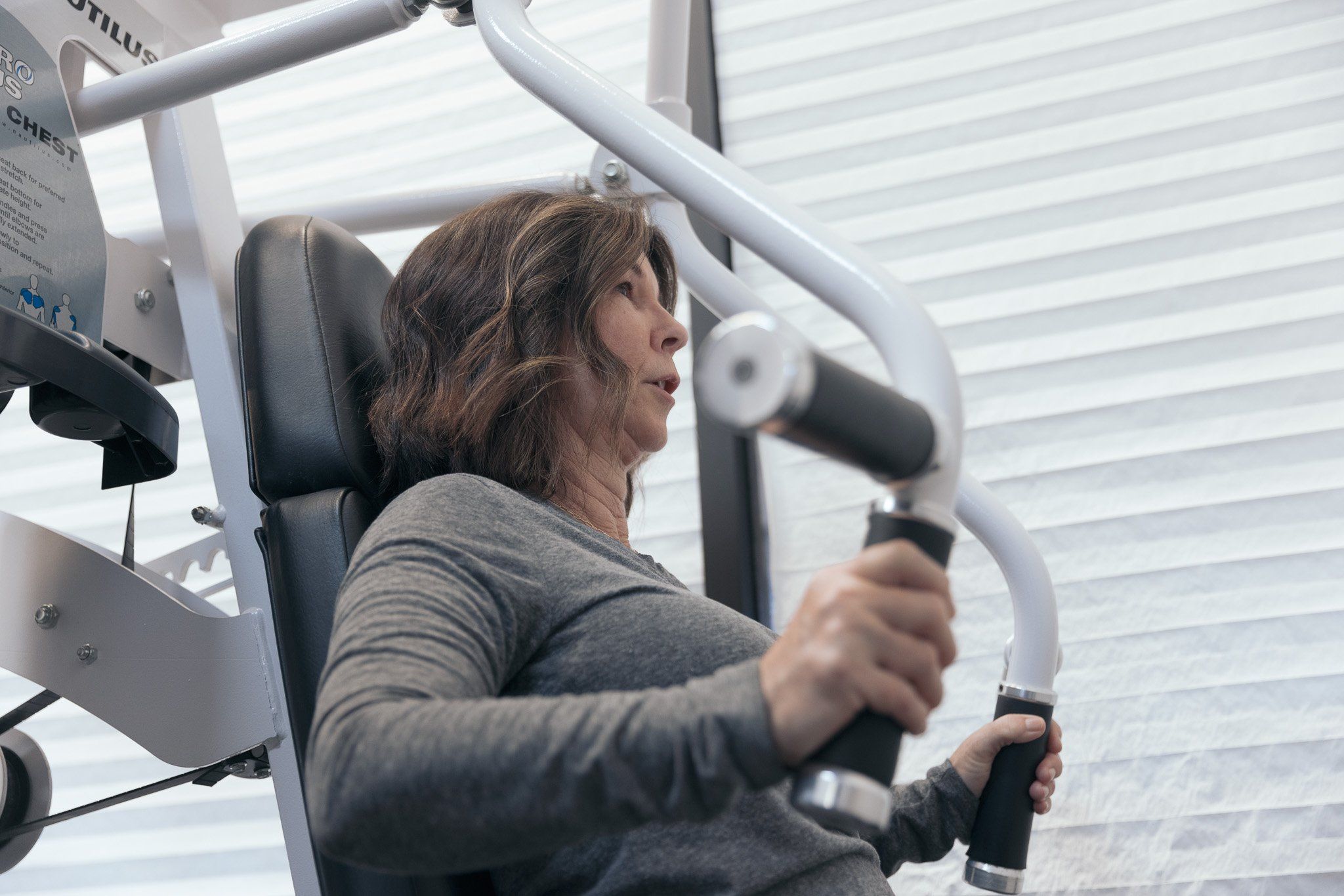 A dedicated female member performing chest exercises