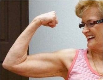 Elderly woman showcasing her muscular arm, displaying the gains from The Perfect Workout.