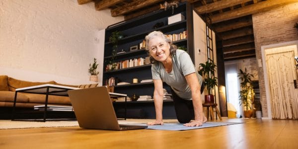 Female virtual training member on a zoom call with her trainer