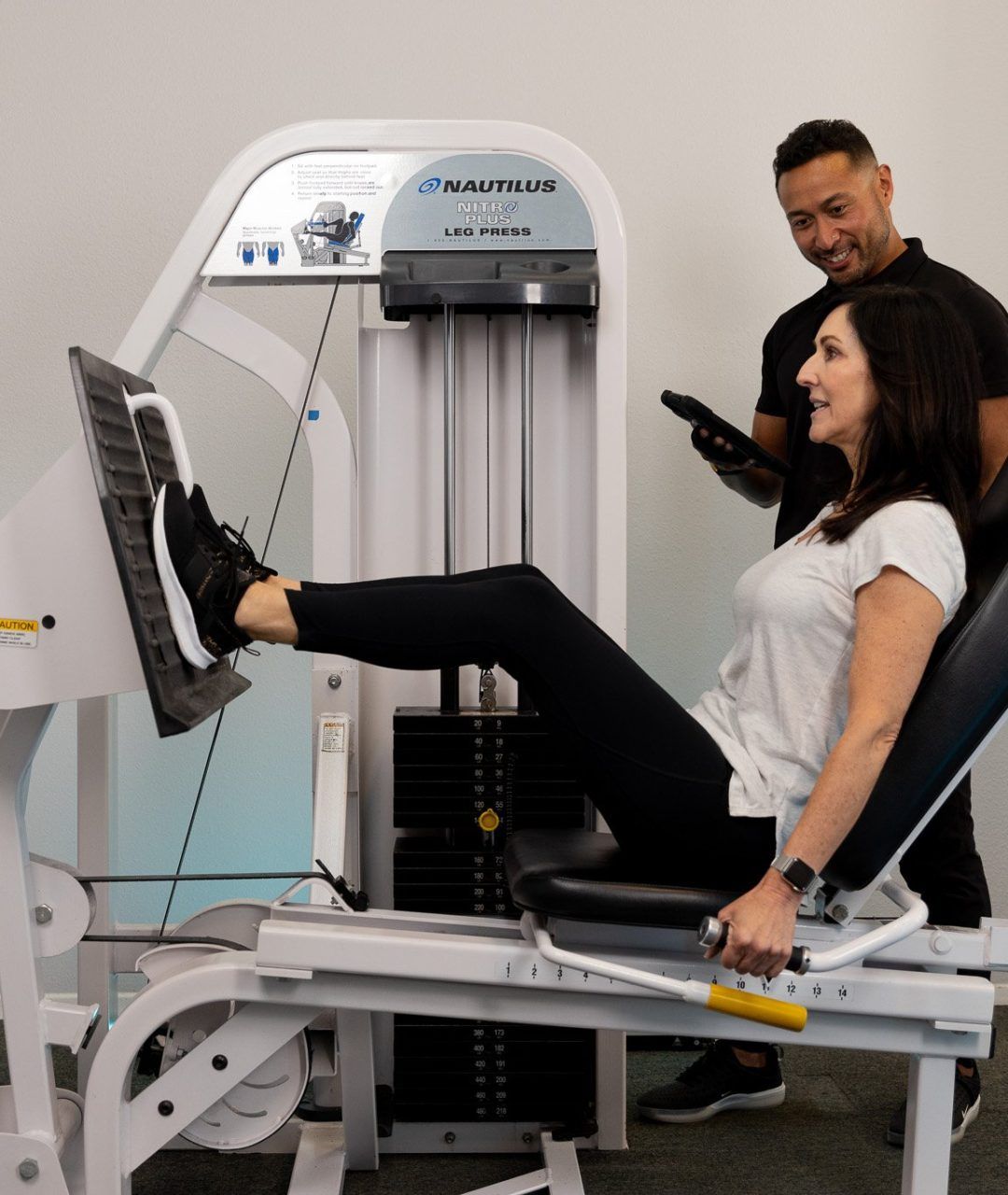 Female trainer at The Perfect Workout doing a leg press