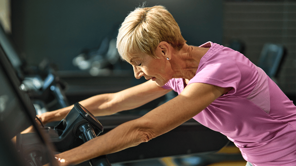 A woman with high cortisol levels is exhausted from overworking herself in the gym