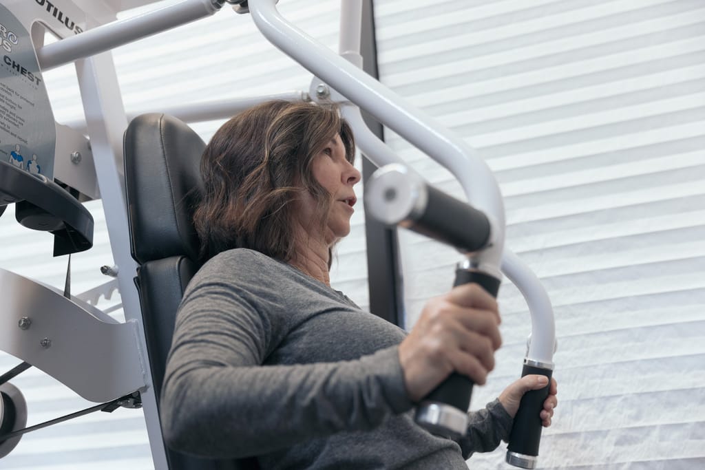 A dedicated female member performing chest exercises