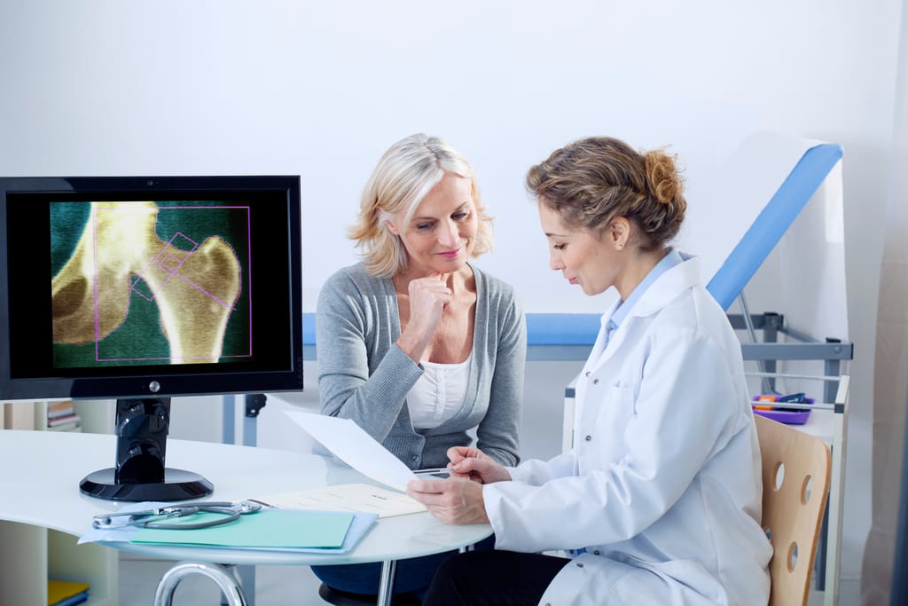 female patient takling to her female doctor about bone health