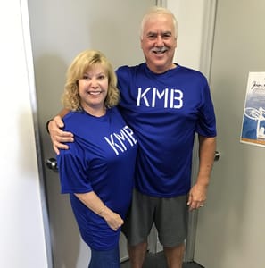 Married couple showing off their results