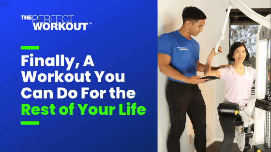 Male personal trainer with female member working in studio