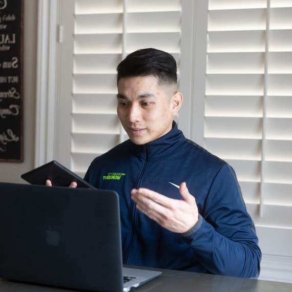 virtual personal trainer on his laptop