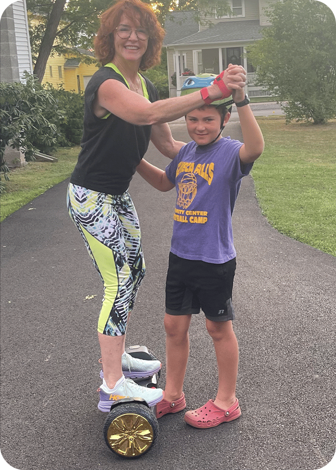 Meg standing on a hoverboard