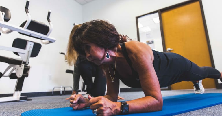 Female planking on a yoga mat
