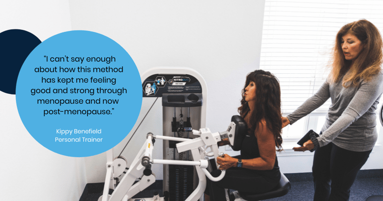 Female trainer coaching female member on the compound row with a quote in it