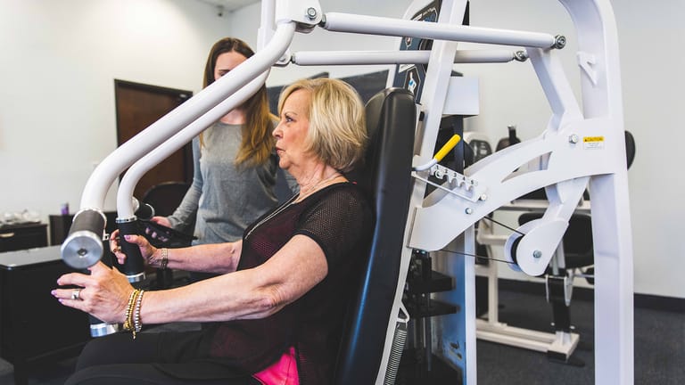 Image of a trainer coaching a female member at The Perfect Workout