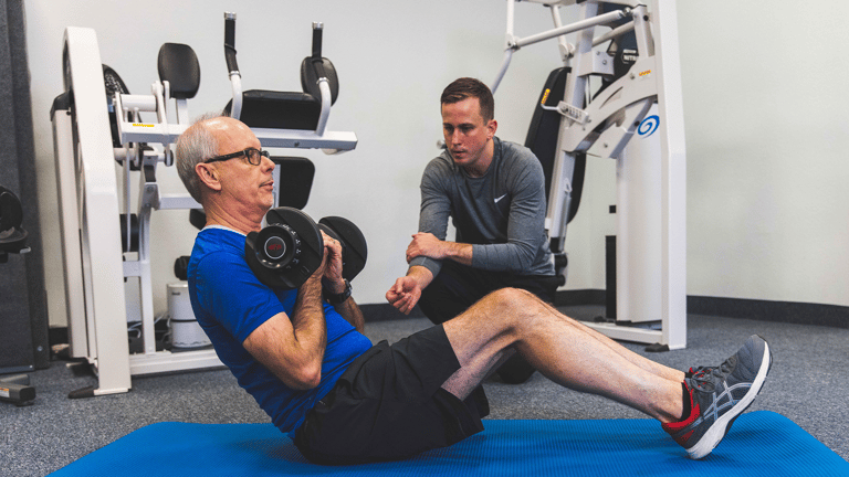 Image of a trainer coaching a member during ab exercises