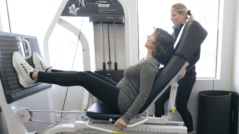 A person working hard on the leg press machine