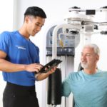Personal trainer sharing client results with client on machine