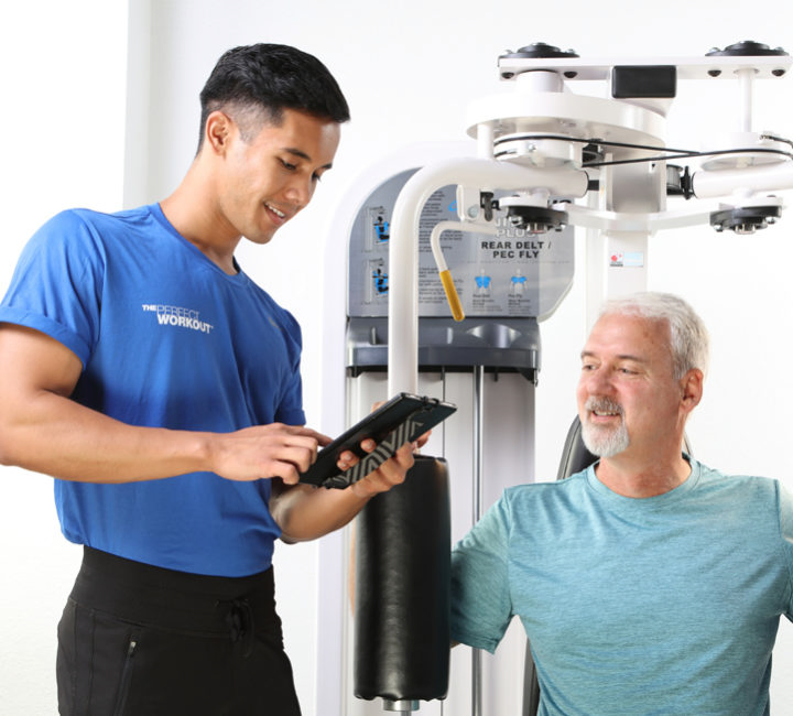 Personal trainer sharing client results with client on machine