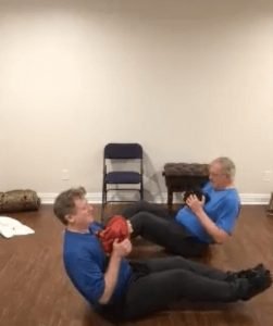 two men working out at home with a Virtual Personal Trainer