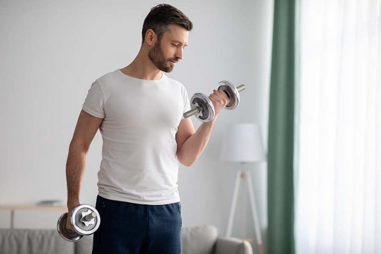 young man strength training with dumbbell