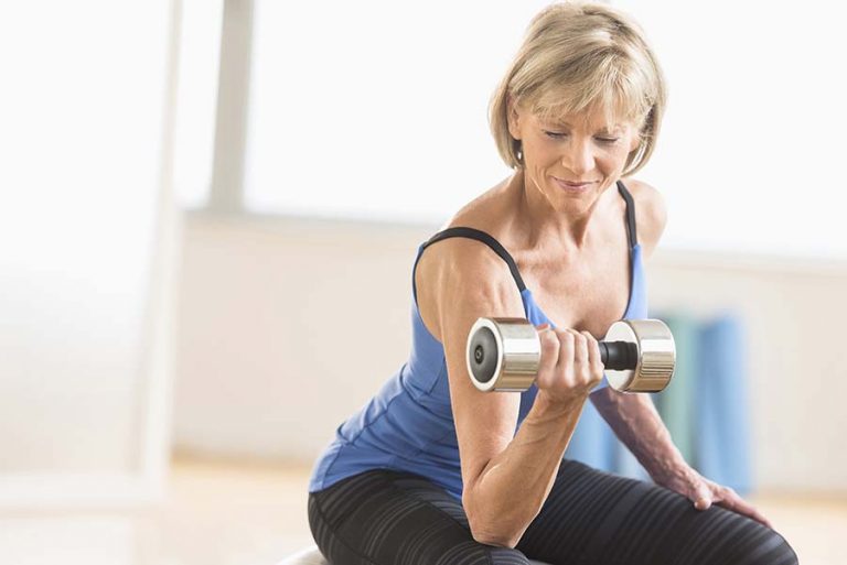 man strength training with a dumbbell
