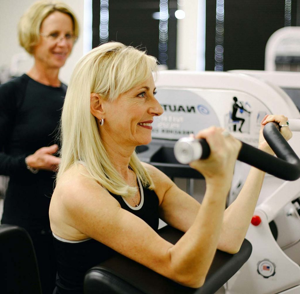 Preacher Curl with Female Client and Female Personal Trainer in Studio