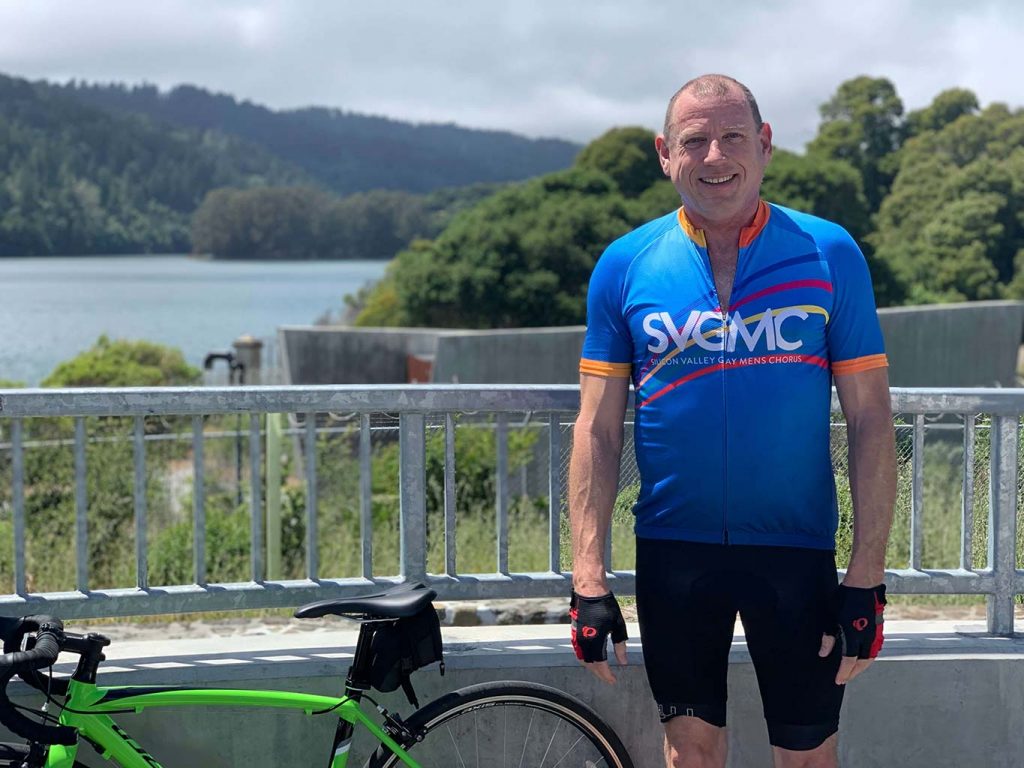 Doug McGrath, Male virtual personal training client standing near his bike