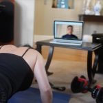 Female Virtual Client working out in front of laptop
