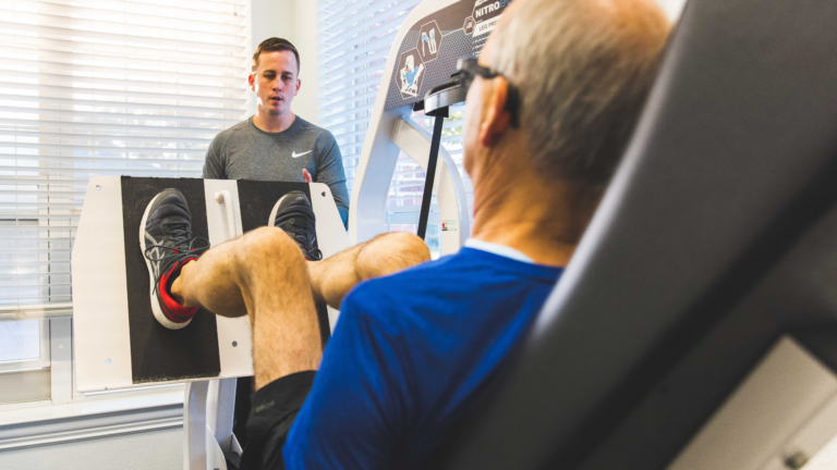 Trainer coaching a male on high intensity training