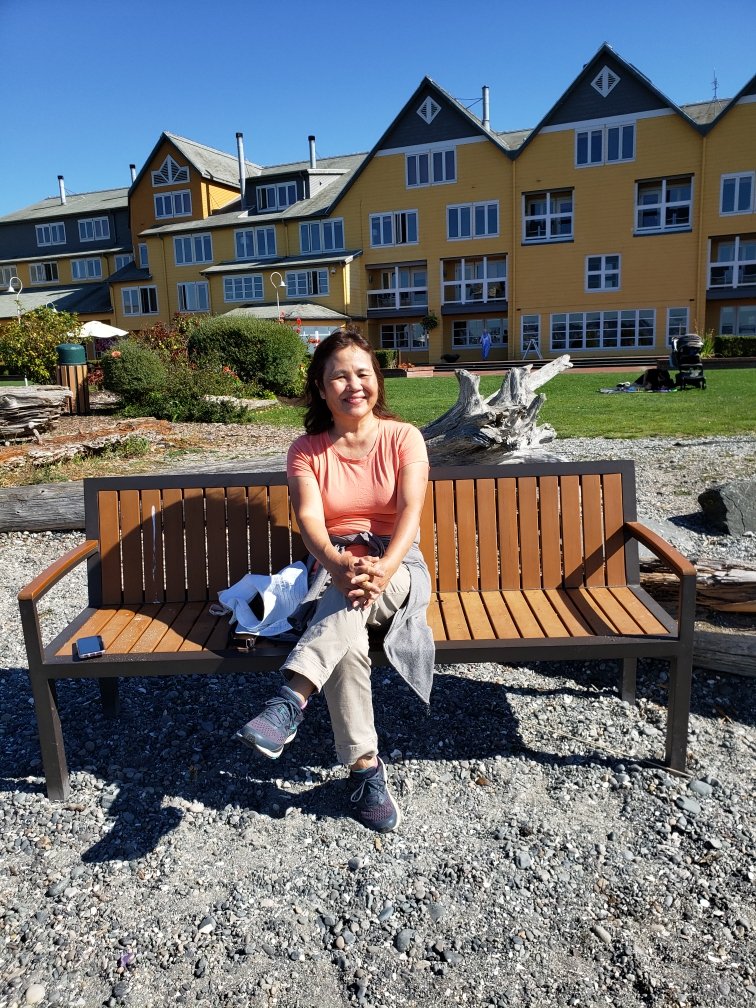 woman sitting on a park bench smiling