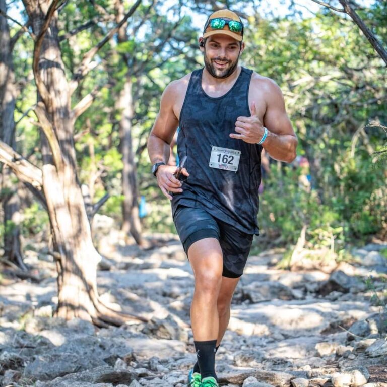 Matthew Medeiros running on a hiking trail