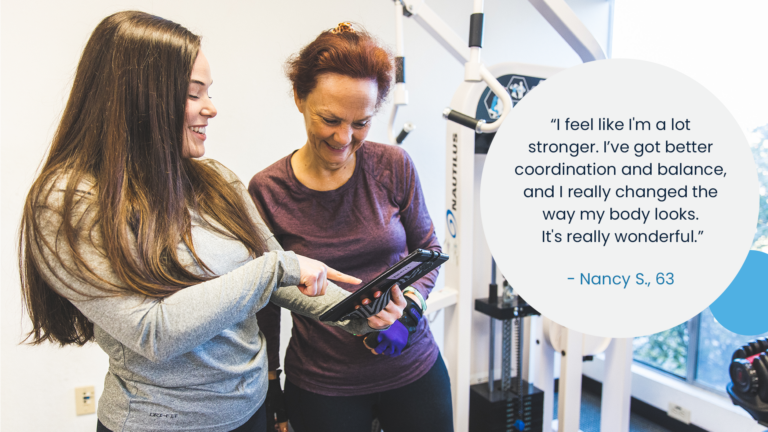 image of a trainer show a member their progress chart with a quote bubble next to them