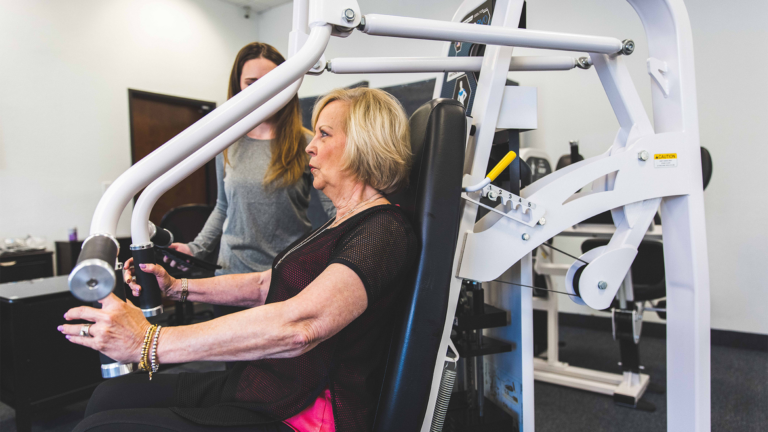 Image of a trainer coaching a female member at The Perfect Workout