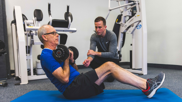 Image of a trainer coaching a member during ab exercises
