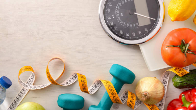 Image of a food scale with food and weights nearby