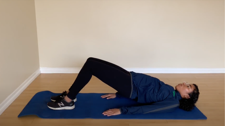 Trainer giving an example of a glute bridge workout