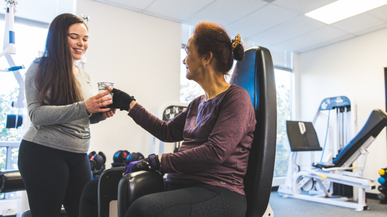 image of a trainer giving a member some water