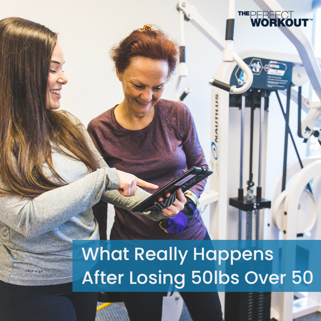A member of The Perfect Workout being shown how much progress they've made by their trainer