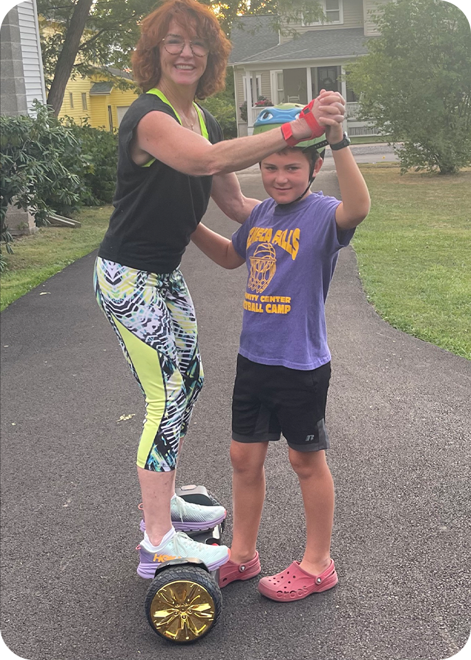 Meg standing on a hoverboard