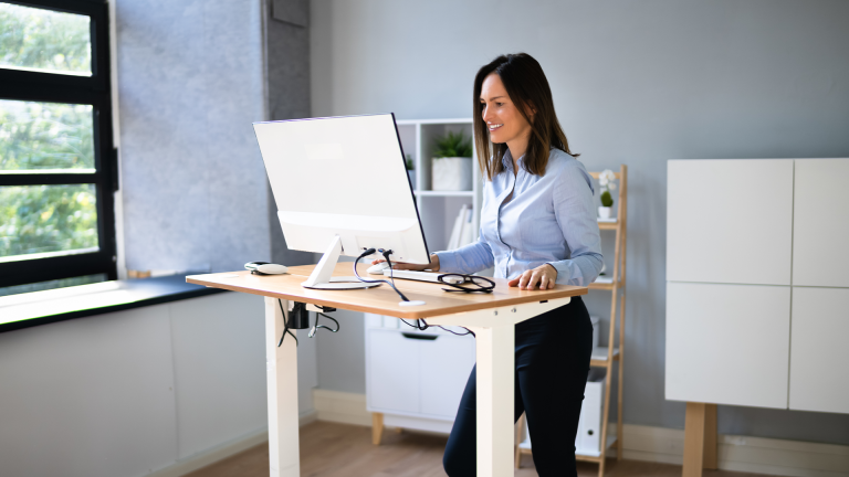 A woman using a standing desk
