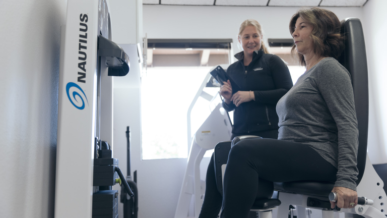 A person workouts using the adduction machine