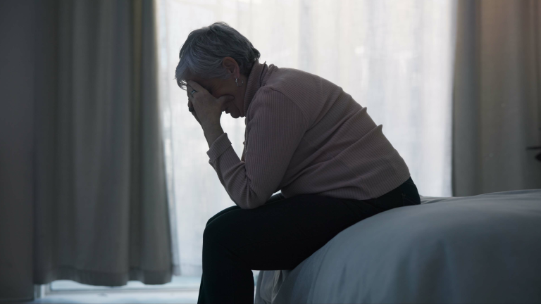 An old woman struggling with anxiety and depression from high cortisol