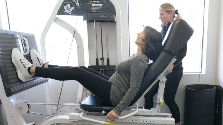 A person working hard on the leg press machine